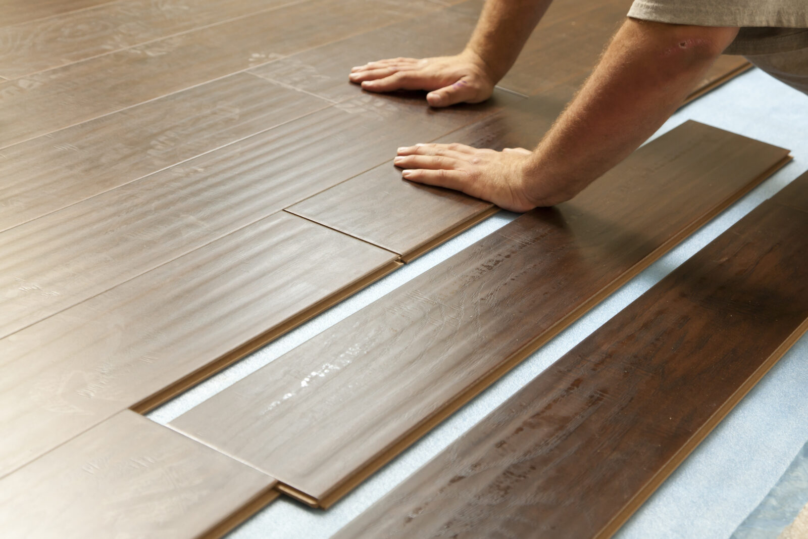 Man Installing New Laminate Wood Flooring | LA Carpet Warehouse, Inc