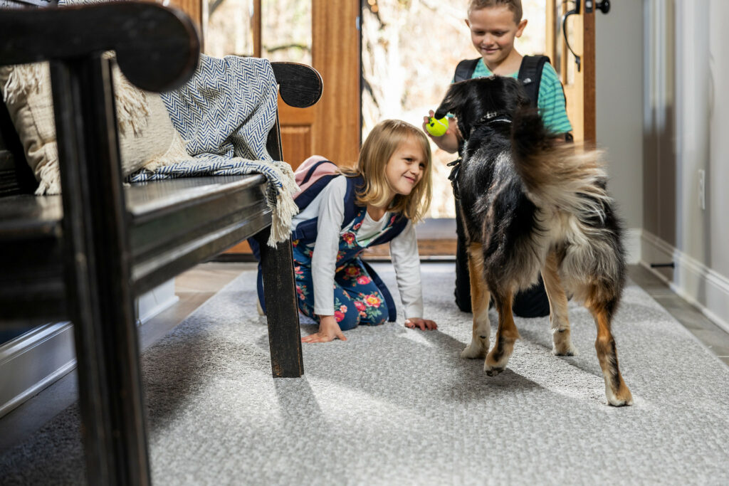 Kids playing with dog on carpet floors | LA Carpet Warehouse, Inc